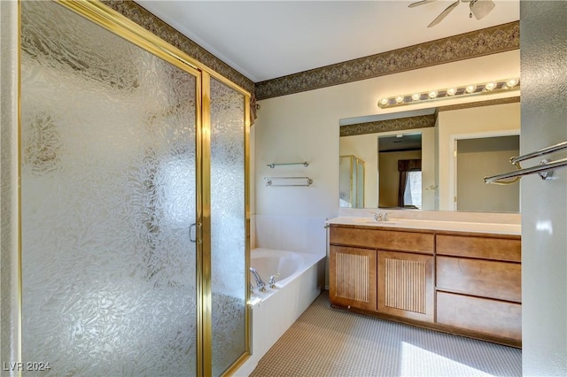 bathroom with plus walk in shower, vanity, ceiling fan, and tile patterned flooring