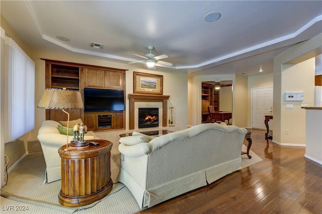 living room featuring dark hardwood / wood-style floors and ceiling fan