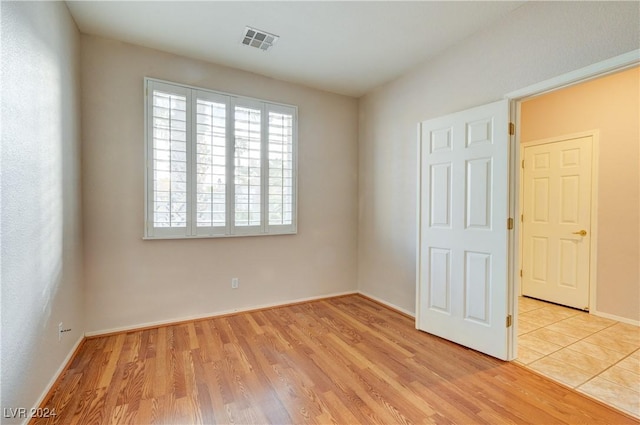 empty room with light hardwood / wood-style floors