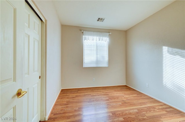 unfurnished bedroom featuring light wood-type flooring and a closet