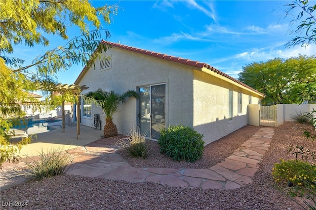 view of side of property with a patio area