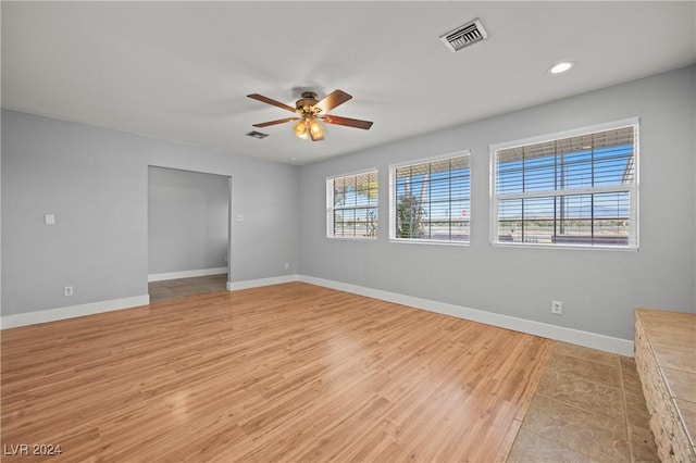 unfurnished room with light hardwood / wood-style flooring and ceiling fan