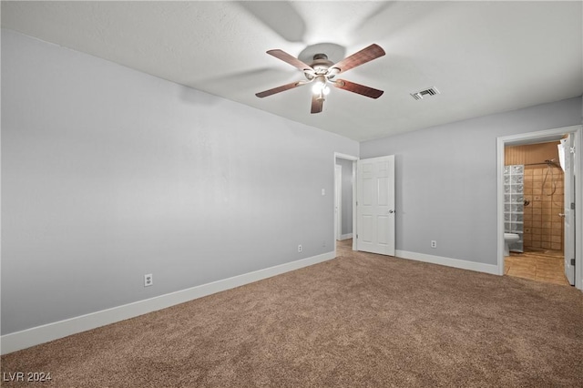 unfurnished bedroom with ensuite bath, ceiling fan, and carpet floors