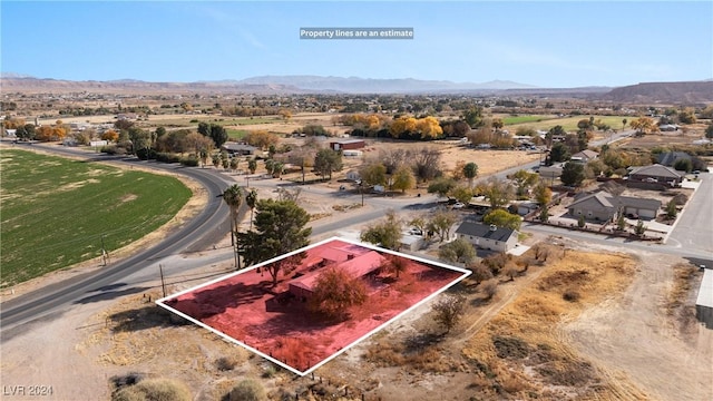 birds eye view of property with a mountain view