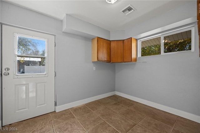 washroom featuring tile patterned floors and plenty of natural light