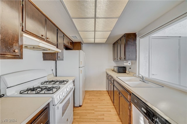 kitchen featuring a drop ceiling, gas range gas stove, sink, light hardwood / wood-style flooring, and dishwasher