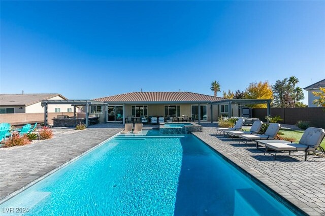 view of swimming pool featuring a patio area, an in ground hot tub, and an outdoor hangout area