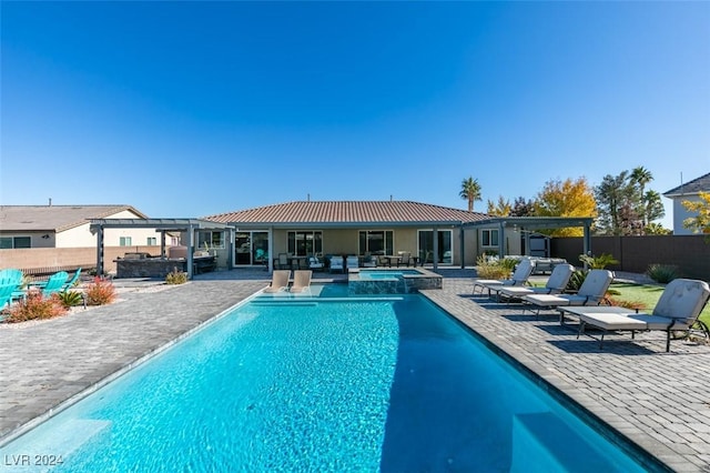 back of house featuring a patio area, a fenced backyard, a pool with connected hot tub, and stucco siding