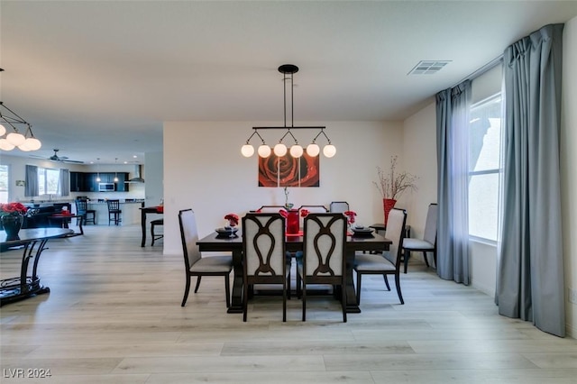 dining area featuring light hardwood / wood-style floors and ceiling fan