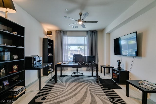 office area with a ceiling fan, visible vents, and light wood-style flooring