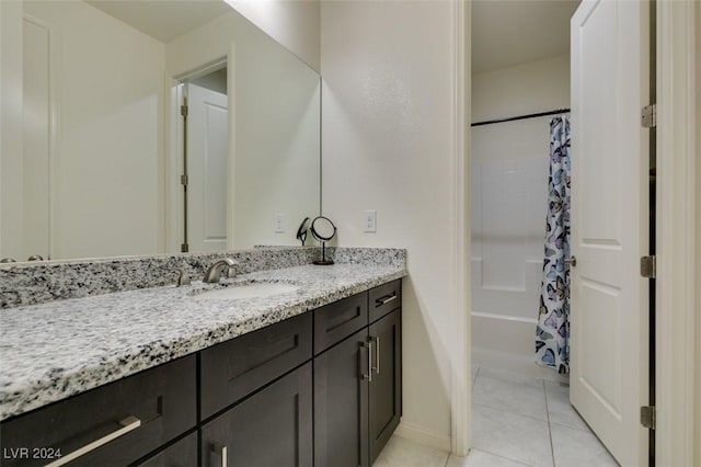 bathroom featuring tile patterned flooring, vanity, and shower / tub combo with curtain