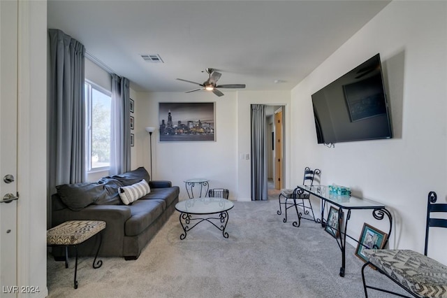 carpeted living area with ceiling fan and visible vents