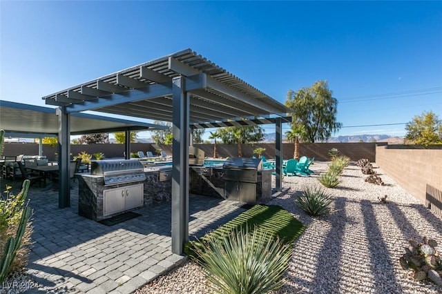 view of patio / terrace featuring a fenced backyard, a pergola, and area for grilling