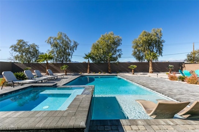 view of pool with a patio area, a fenced backyard, and a pool with connected hot tub