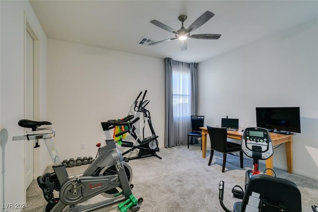 exercise area featuring light colored carpet and ceiling fan