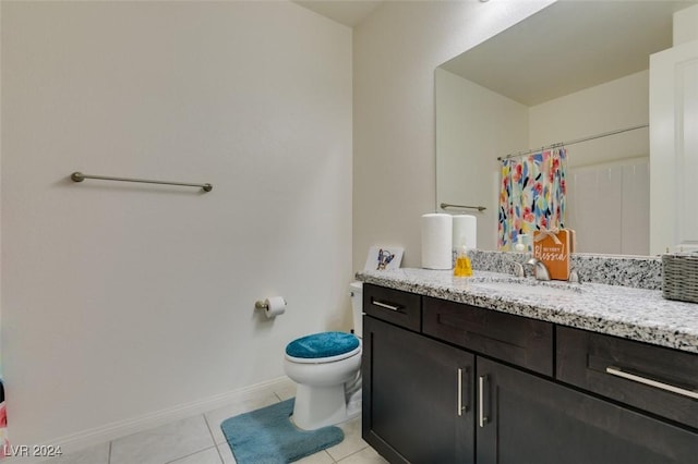 bathroom with a shower with shower curtain, toilet, vanity, baseboards, and tile patterned floors