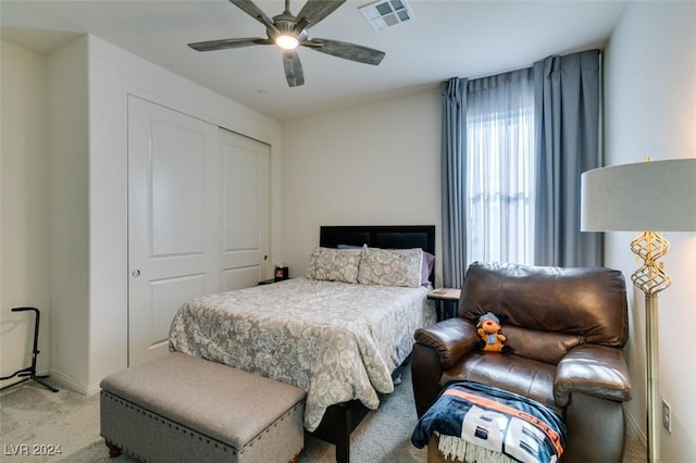 bedroom featuring light carpet, a closet, and ceiling fan