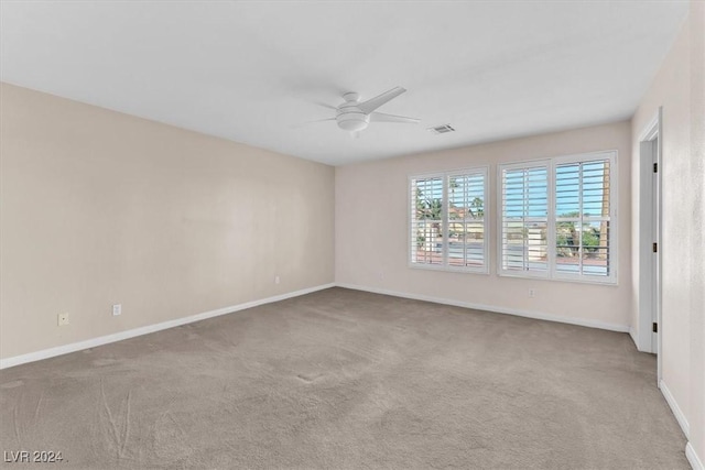 unfurnished room with ceiling fan and carpet floors