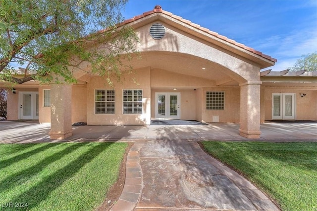 rear view of house featuring a patio area and french doors