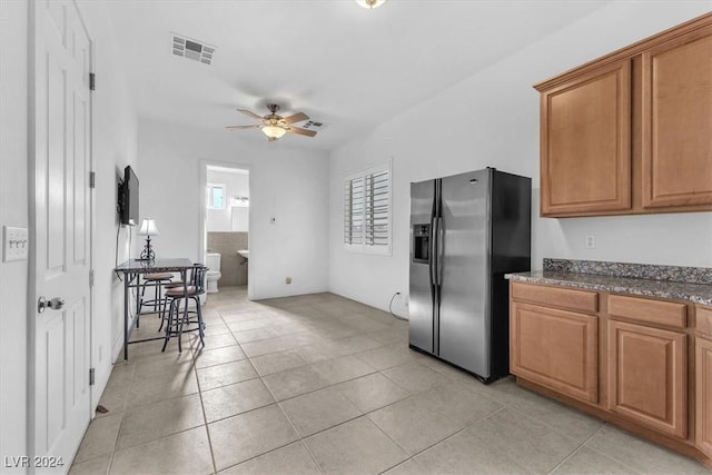 kitchen featuring stainless steel fridge with ice dispenser, ceiling fan, and light tile patterned flooring