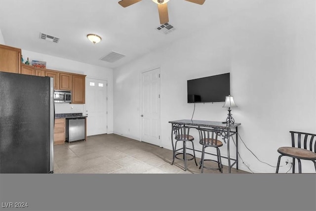 kitchen featuring ceiling fan, light tile patterned flooring, and appliances with stainless steel finishes