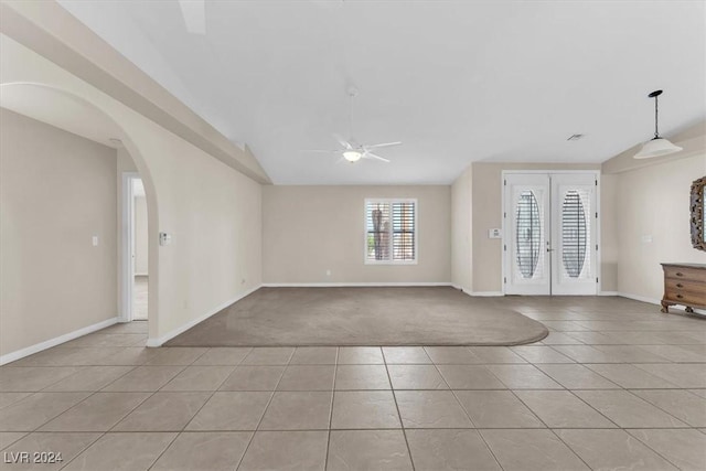 carpeted foyer featuring ceiling fan, french doors, and vaulted ceiling