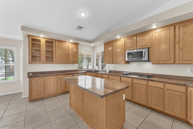 kitchen with plenty of natural light, a center island, stainless steel appliances, and lofted ceiling