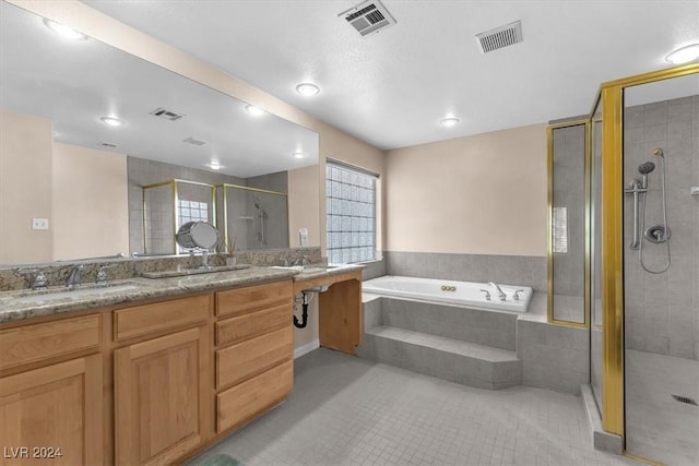 bathroom featuring tile patterned floors, vanity, and independent shower and bath