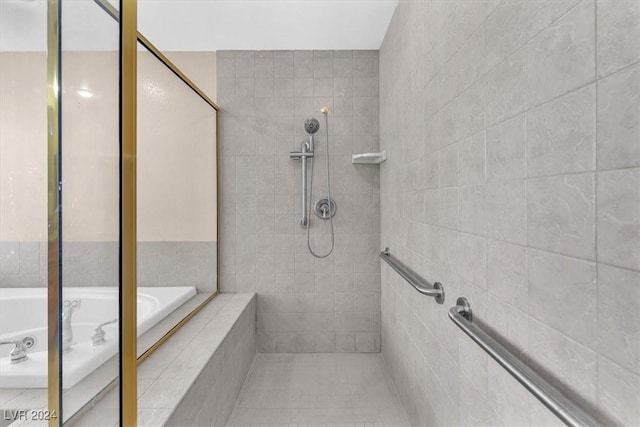 bathroom with tile patterned flooring and separate shower and tub