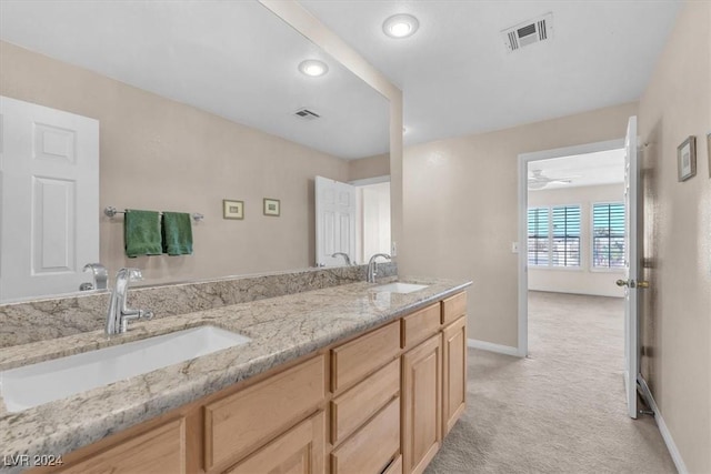 bathroom with ceiling fan and vanity