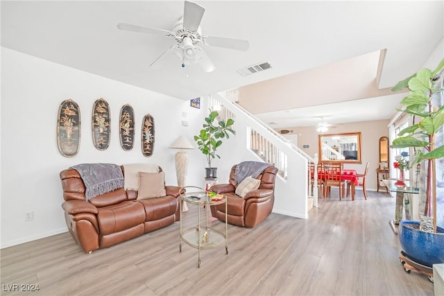 living room featuring ceiling fan and light hardwood / wood-style floors