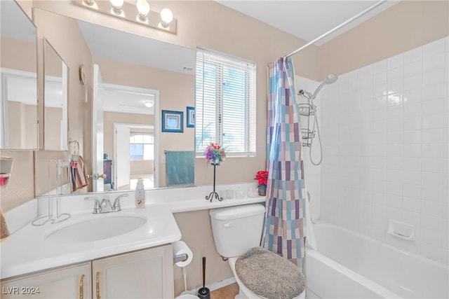 full bathroom with shower / tub combo, vanity, and toilet