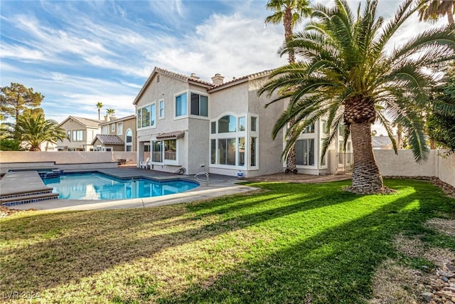 back of house featuring a yard and a patio