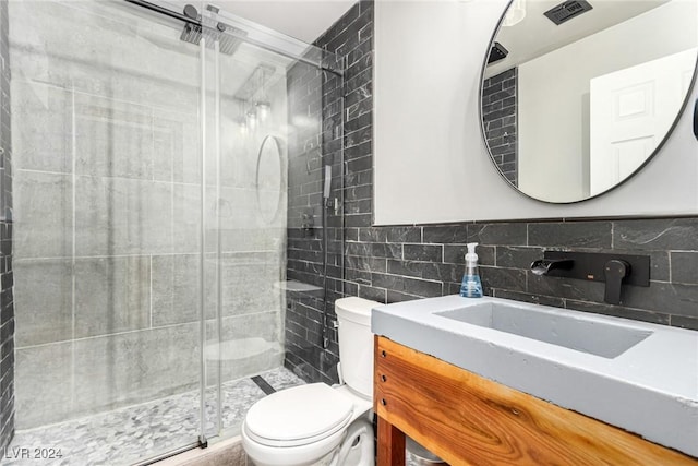 bathroom with vanity, toilet, walk in shower, and tile walls