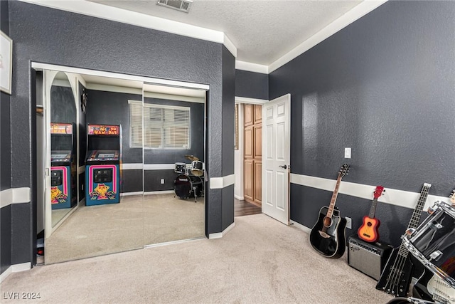 interior space featuring carpet floors and a textured ceiling