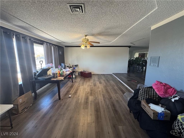 dining area with hardwood / wood-style flooring, ceiling fan, and a textured ceiling