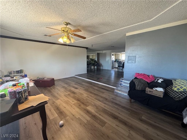 living room with wood-type flooring and a textured ceiling