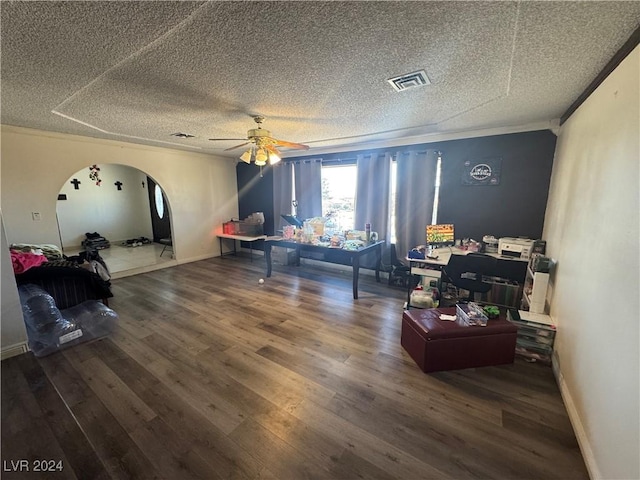 interior space featuring a textured ceiling, ceiling fan, crown molding, and dark hardwood / wood-style floors