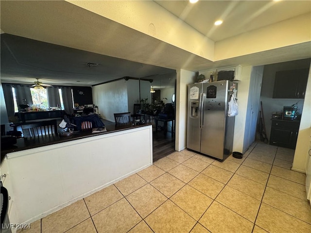 kitchen with ceiling fan, light tile patterned floors, white cabinets, and stainless steel refrigerator with ice dispenser