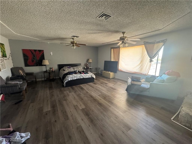 bedroom with ceiling fan, a textured ceiling, and hardwood / wood-style flooring