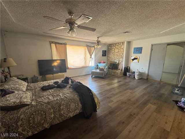 bedroom featuring a textured ceiling, a closet, ceiling fan, and dark wood-type flooring