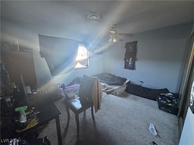 bedroom featuring carpet, ceiling fan, and a textured ceiling