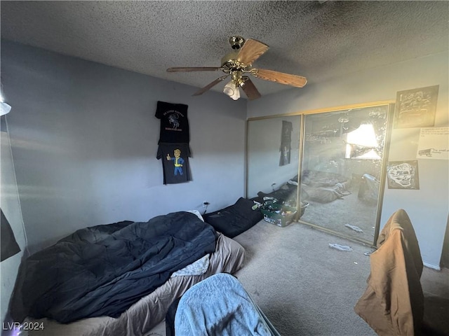 carpeted bedroom featuring ceiling fan, a textured ceiling, and a closet