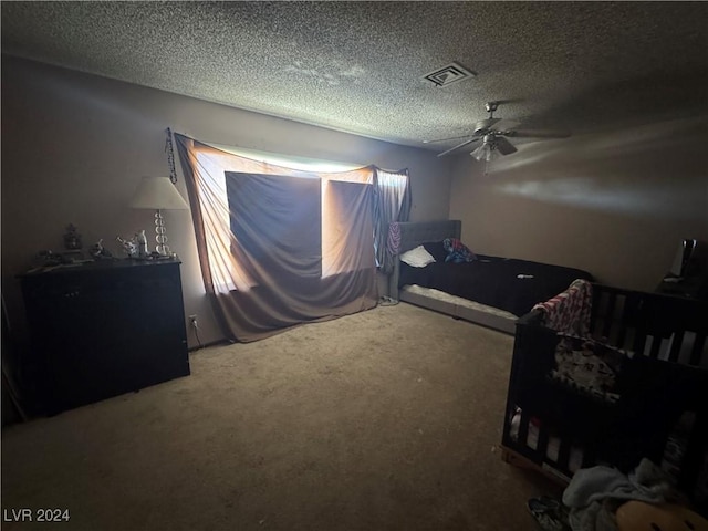 carpeted bedroom featuring a textured ceiling and ceiling fan