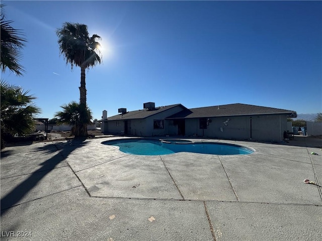 view of pool featuring an in ground hot tub and a patio area