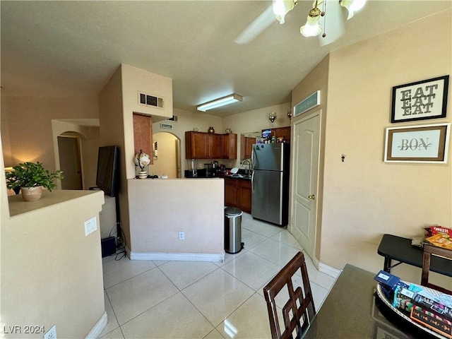 kitchen featuring stainless steel fridge and light tile patterned flooring