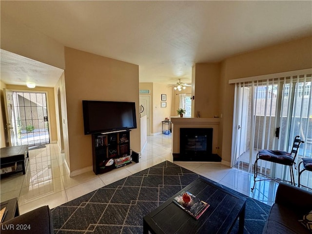 living room featuring ceiling fan and light tile patterned floors