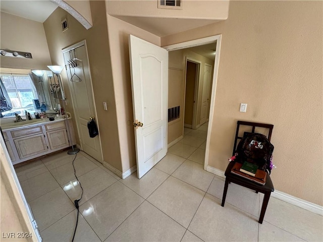 hall with light tile patterned floors