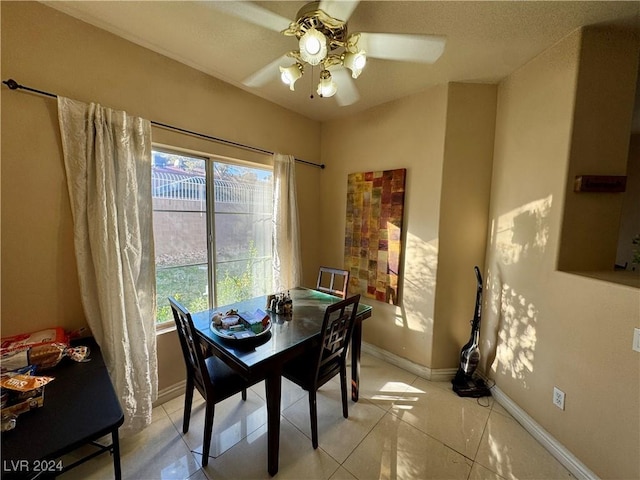 dining room with light tile patterned floors and ceiling fan