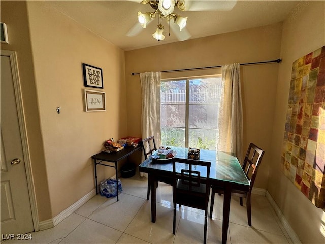 tiled dining area with ceiling fan